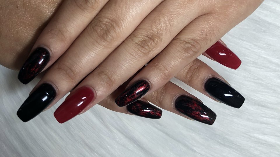 Nail technicians working on manicures and pedicures.