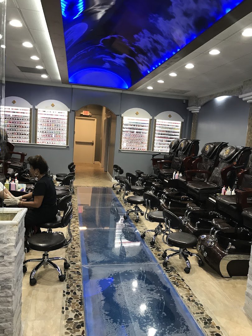 Nail technicians working on manicures and pedicures.